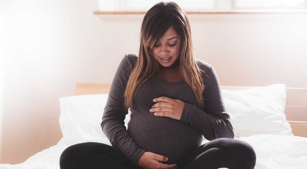 Pregnant woman holding belly