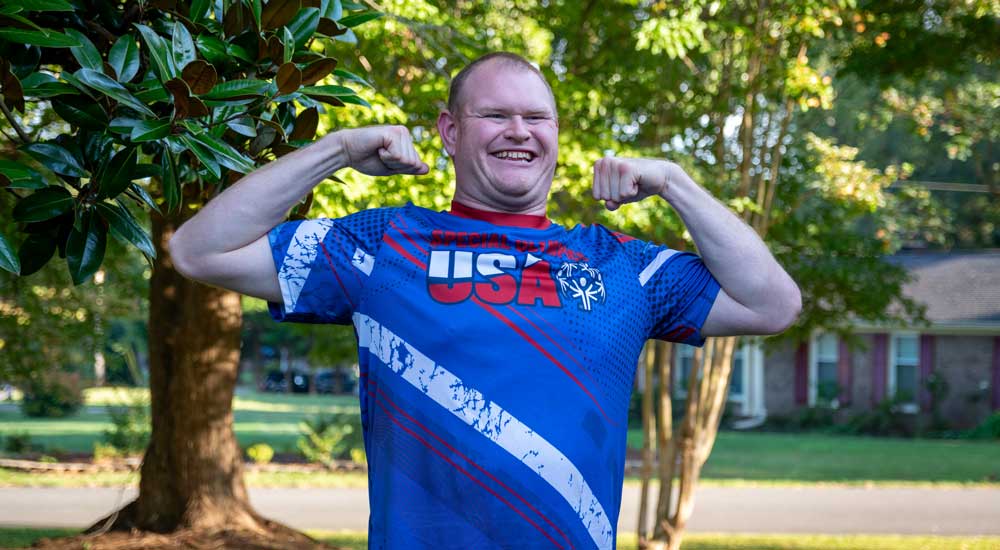 man with arms flexed and usa shirt