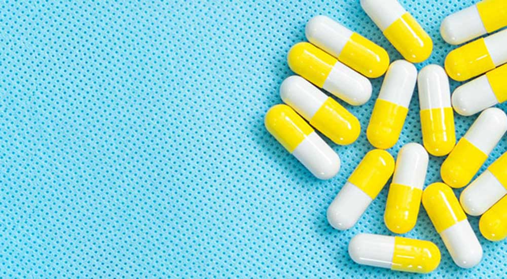 Blue background with bright yellow pills