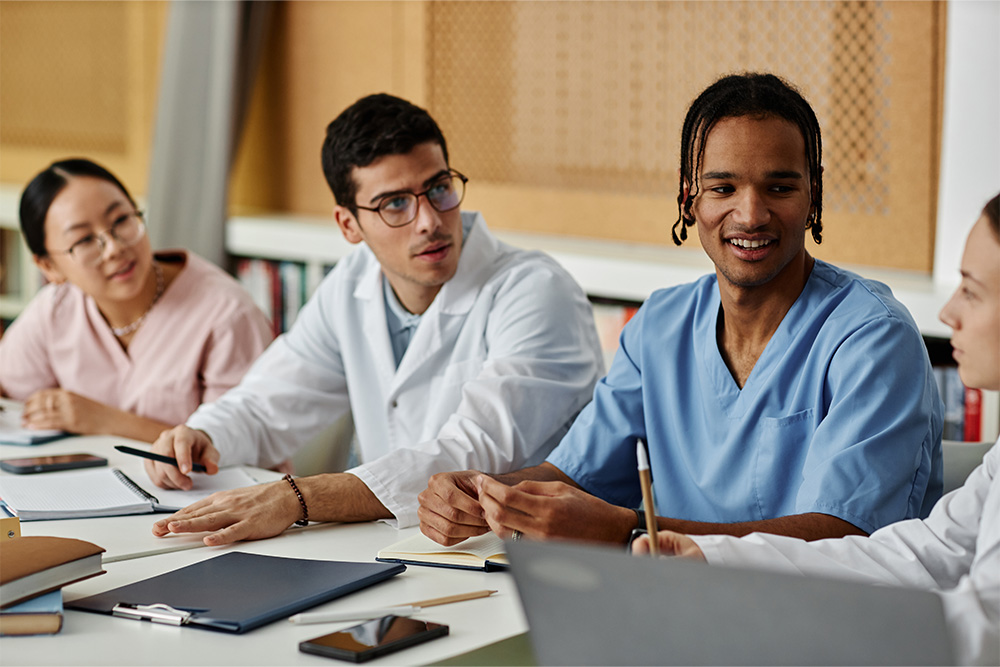 A group of doctors engaged in discussion while sitting around a table.